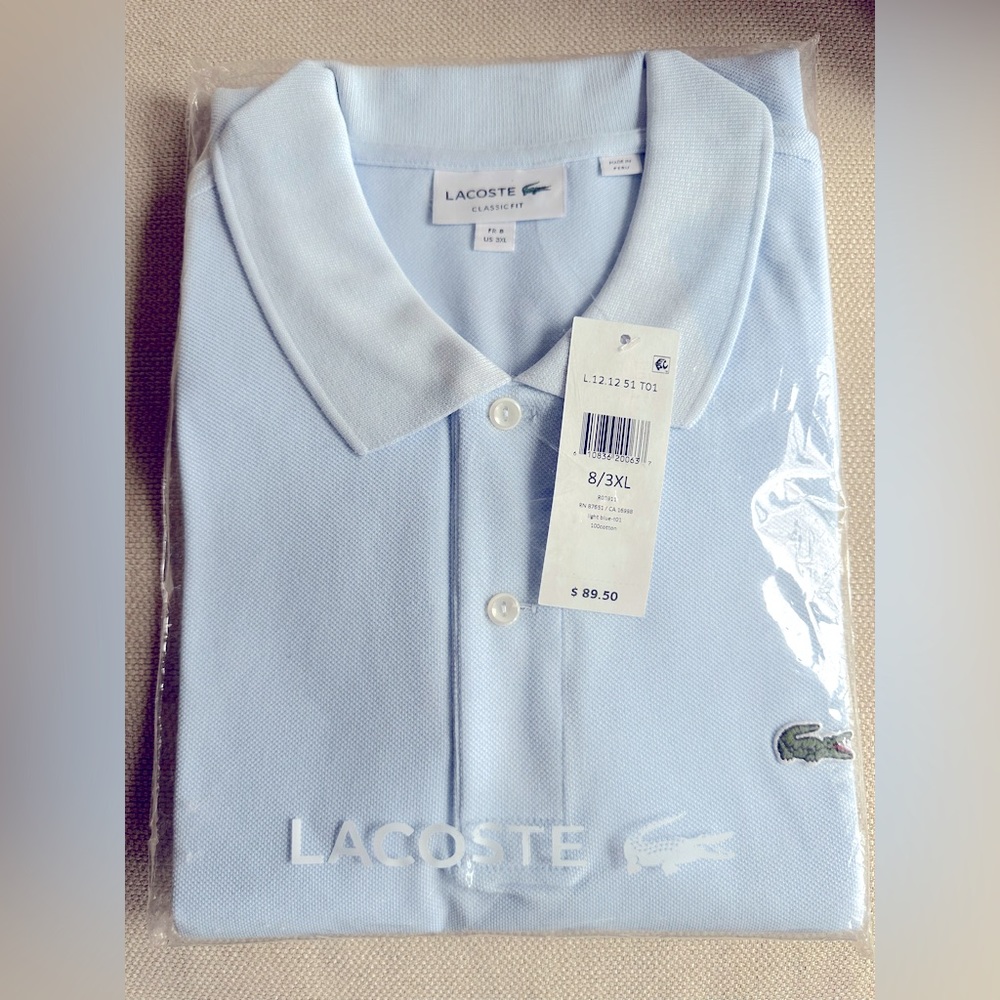 🦈 Brand new with tags is a baby blue 3XL classic Lacoste polo made in Peru.